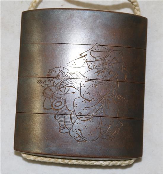 A Japanese togidashi lacquer three case inro, signed Koma Koryu Saku and kakihan, 19th century, losses to decoration on netsuke